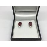 A boxed pair of 18ct white gold, ruby and diamond