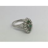 An 18ct white gold, diamond and emerald marquis shape cluster ring, approx 5.9g and approx size N.