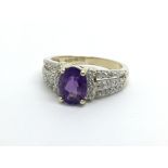A 9ct gold ring set with a central amethyst and di