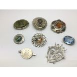 Eight silver and white metal brooches, some set with Scottish agate.