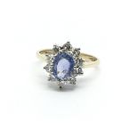 A 9ct gold ring set with a central sapphire and su