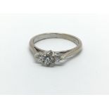 An 18ct white gold three stone diamond ring, approx 2.6g and approx size L.