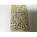A Quality late 19th century carved ivory card case profusely carved with figures.