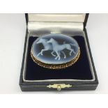 A cameo brooch of horses set within a 9ct gold frame, approx width 4.5cm.