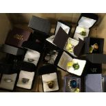 A box containing a quantity of silver rings mounted with coloured stones some silver gilt (a lot)