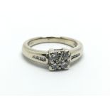 An 18ct gold ring set with four princess cut diamo