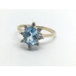 A 9ct gold topaz and diamond cluster ring, approx