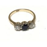 An 18carat gold ring set with a blue sapphire flanked by old cut diamonds. Ring size N-O