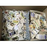A box containing a large collection of Brooke Bond tea cards and others