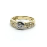 An 18ct gold solitaire diamond ring with further d