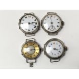 Four small silver watch faces, two having Roman numerals and one with an extra dial