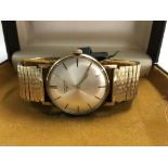 A Longines wrist watch with gold plated strap and