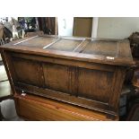 An oak chest with a hinged top and linen interior 96cmx 50cm