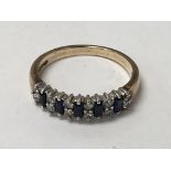 A 9carat gold ring set with blue sapphire and smal