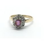 An 18ct gold ruby and diamond cluster ring, approx