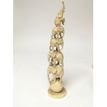 A late 19th century carved ivory tusk in the form of a stack of graduating elephants. Height 26cm