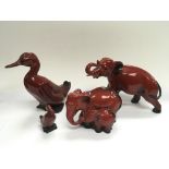 Four Royal Doulton flambe ware animal figures comprising elephants and ducks.