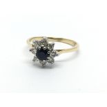 An 18ct gold ring set with a central sapphire and