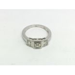 An 18ct white gold three stone princess cut diamon