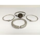 Four sterling silver bangles.