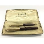 A cased set of Sheaffer pens comprising a fountain pen with a 14k gold nib and one other.