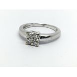 An 18ct white gold ring set with four diamonds, ap