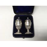 Interesting pair of H/M silver small urn shaped salt and pepper pots with lift of lids. H/M
