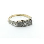 An 18ct gold and platinum three stone diamond ring