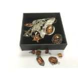 A small collection of amber and silver jewellery.