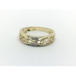 A 9ct gold open work ring set with small diamonds,