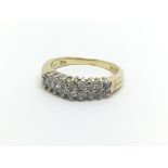 A gold ring set with two rows of diamonds, approx.