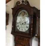 A 19th century inlaid oak longcase clock with a painted dial maker Deacon Barton with an eight day