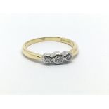 An 18ct gold three stone diamond ring, approx .15c