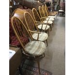 Six light wood Ercol dining chairs comprising two carvers and four others.