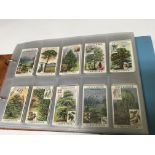 An album of cigarette cards including “ Henry “, Boxing, Whitbread signs etc