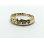 A vintage 18ct gold ring set with five small diamo