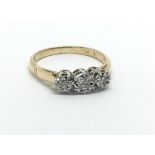 A gold and platinum three stone diamond ring, appr