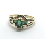 An 18ct gold emerald and diamond cluster ring, app