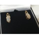 A pair of opal doublet and chip stone diamond earrings in a fitted box.
