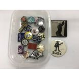 A small collection of music related pin badges inc