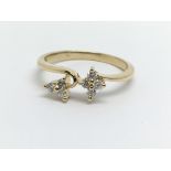 An 18ct gold seven stone flower design diamond rin