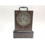 A small walnut and fruitwood inlaid campaign clock