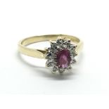 An 18ct gold ruby and diamond cluster ring, approx