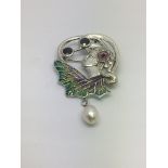 A silver floral brooch set with a suspended pearl
