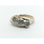 A 9ct gold ring set with diamonds in the form of t
