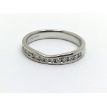 An 18ct white gold half eternity diamond ring, app