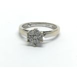 An 18ct white gold diamond cluster ring in the for