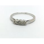 An 18ct white gold three stone diamond ring, appro