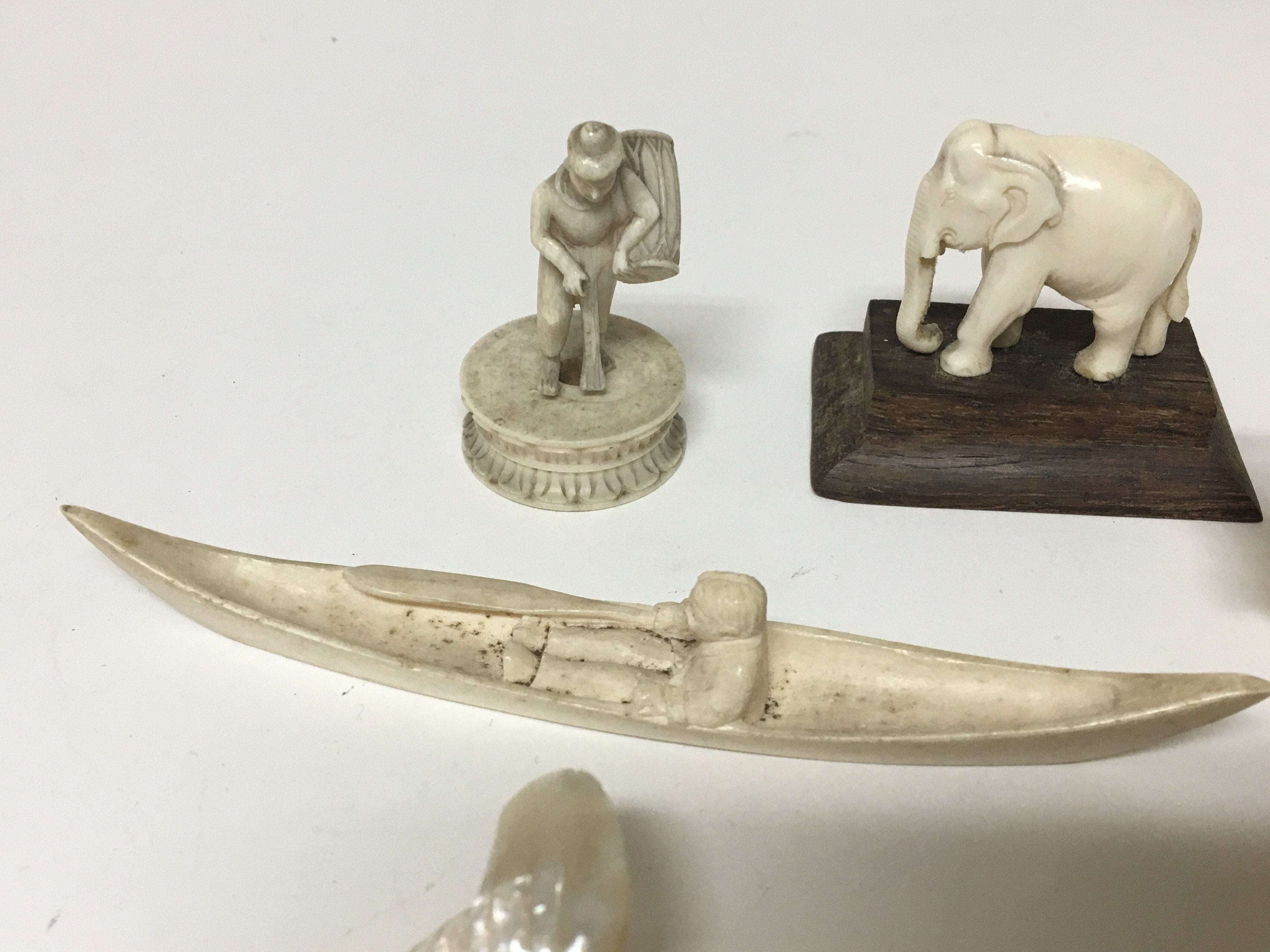 A collection of small carved ivory and bone figures and a mother of pearl carving in the form of a - Image 2 of 2