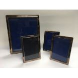 Four silver plated photo frames.